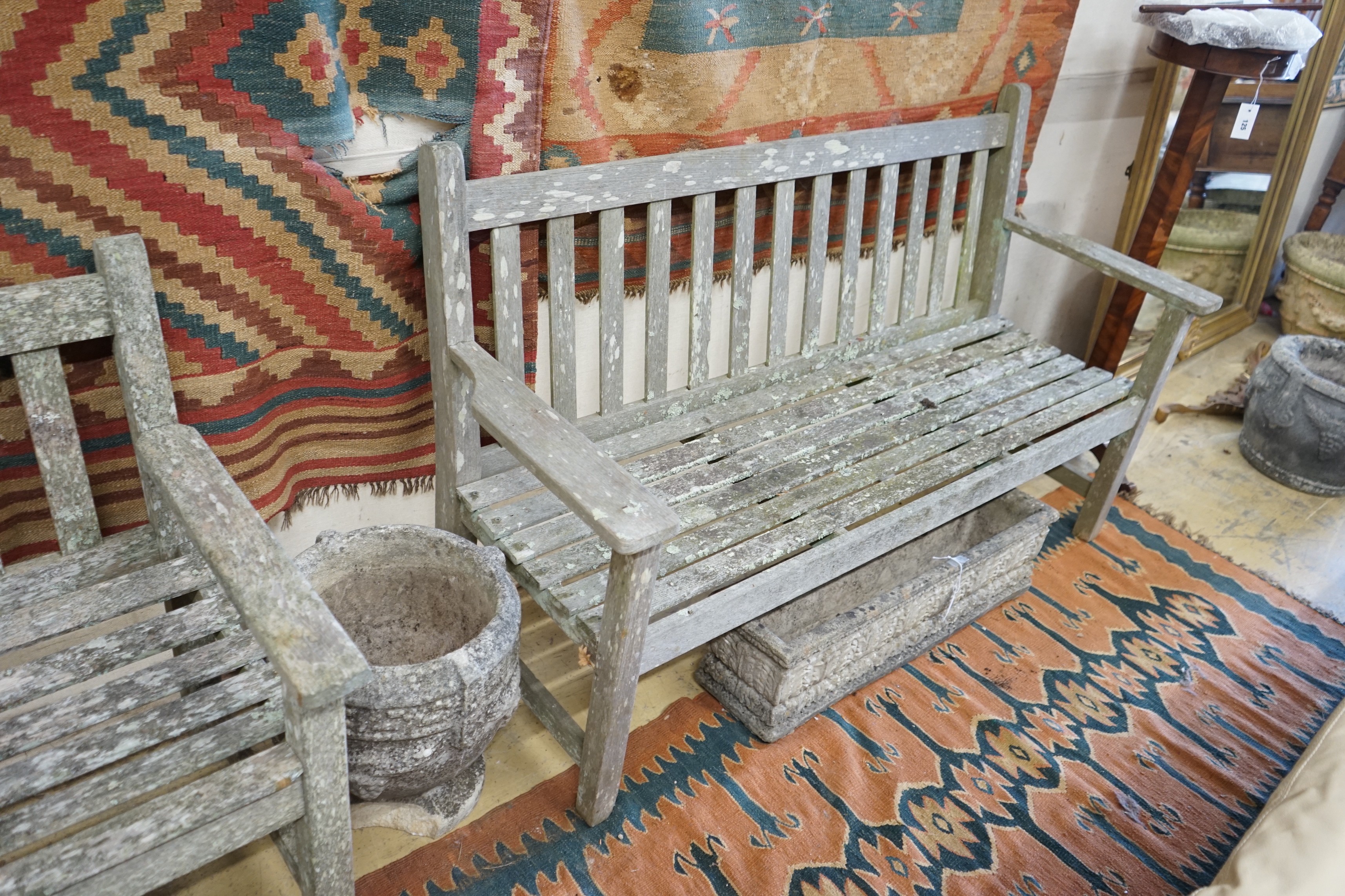 A near pair of weathered slatted teak garden benches, larger length 155cm, depth 56cm, height 90cm